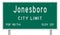 Green road sign showing population and elevation for Jonesboro Arkansas