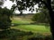 a green rolling golf course with a lake