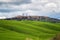 Green rolling hills and old town of Pienza