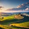 The green rolling Tuscany fields are in the warm light of the setting sun.