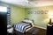 Green room of boy child teenager with navy striped bedding and curtains