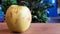 Green rotten apple on a wood background. Green apple on a old wooden background, top view. Organic juicy bio apple ugly, with