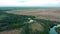 Green russian field and horizon drone aerial zoom out shot