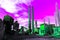 Green rusty pipes and factory emitting radiation produce smog into the bright poisonous purple sky, the concept of pollution and