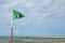 Green safety flag at the beach: swimming allowed