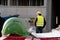 Green safety hardhat on foreground. Construction worker on background