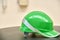 Green safety helmet on a table