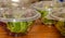 Green salad mix inside transparent take away bowl packages. Baby spinach, arugula, lettuce, rocket, romaine in disposable plastic
