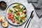 Green salad with tomatoes and salmon on a concrete background. Top view with place for text