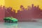 Green saloon car toy selective focus on blur city background