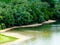 green and sand color river shore panorama along the Danube river in Hungary