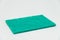 Green Scouring pad with white background and selective focus