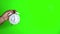 Green screen chroma key footage of a males hand holding and old fashioned alarm clock saying 7pm or 7am