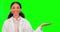 Green screen, doctor and woman with palm space in studio isolated on a background. Face portrait, medical scientist and