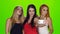 Green screen. Girls pose for the camera of the smartphone