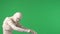 Green screen isolated chroma key photo capturing a mummy staggering, walking from one side of the frame to the other