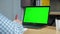 Green screen laptop concept: Businessman at office sits table writes in notebook