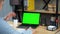 Green screen laptop concept: Laughing businessman tells online video call chat