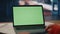 Green screen laptop factory specialist table close up. Unknown engineer looking