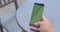 Green screen mobile cellphone scrolling by finger in hand