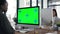 Green screen, mockup and tracking markers with business people at work on computer . Women workers at company desk in