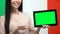 Green screen tablet in female hand against Italian flag, traveling app, emigrant