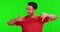 Green screen, thumbs up and down and confused Asian man with doubt, decision and choice in studio. Unsure, hand sign and