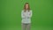 Green Screen. Upset Girl Keeps Her Arms Folded, Woman Looking at the Camera
