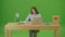 Green Screen Young Pretty Motivated Girl is Writing Down Notes in Paper Notebook