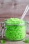 Green scrub in a glass jar