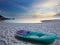 Green sea kayak on sand beach