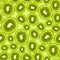 Green seamless pattern with ripe kiwis for summer. Repetitive background with citric fruits.