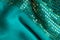 Green sequine background texture abstract cloth wavy folds textile