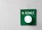 Green `In Service` button signal on the painted grey wall