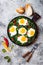 Green shakshuka with spinach, kale and peas. Healthy delicious breakfast. Top view, overhead, flat lay.