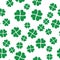 Green shamrock seamless pattern. Background of fourleaf clovers. Simple flat vector illustration