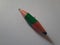 Green short pencil that is sharpened on both sides, bullet shaped