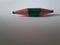 Green short pencil that is sharpened on both sides, bullet shaped