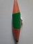 Green short pencil that is sharpened on both sides, bullet shaped