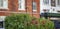 Green shrubs before a red brick building in london