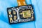 Green silicon die with photodiodes array on electronic PCB detail with orange flex cable