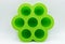 Green silicone molds for cupcakes and muffins, isolated on white