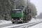 Green Sisu SM300 Truck Hauls Forestry Equipment in Winter