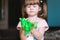 Green slime in children`s hands. A little girl is playing with slime. The child squeezes the green slime through his fingers. Chil