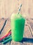 Green Slushie Drink in Plastic Cup with Straws