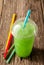 Green Slushie Drink in Plastic Cup with Straws