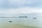 Green small fishng boat parked at the shore of Prachuap Bay with