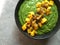 Green smoothie bowl with chopped mango and chia seeds