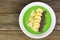 Green smoothie bowl on a wood background