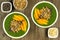 Green smoothie bowls with mangoes on wood background